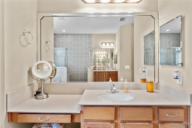 bathroom featuring vanity and tiled shower