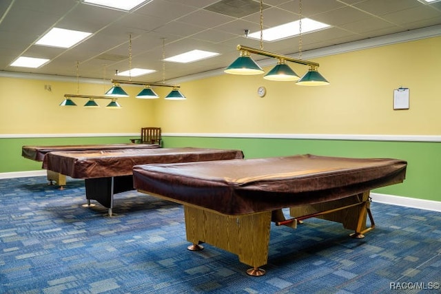 game room with dark carpet, a drop ceiling, ornamental molding, and billiards