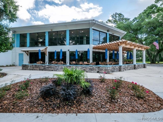 view of property's community featuring a pergola and a patio