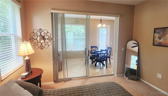 interior space featuring carpet floors and an inviting chandelier