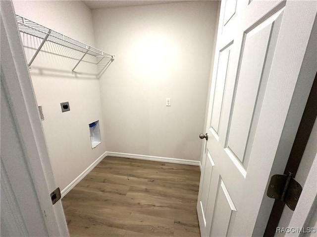 laundry area featuring electric dryer hookup and hardwood / wood-style floors