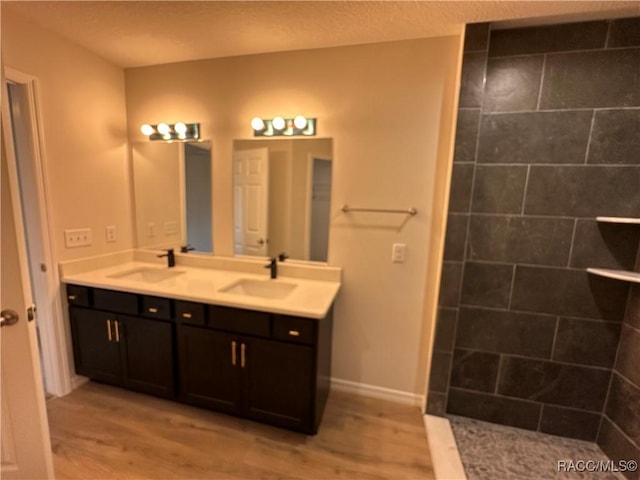 bathroom featuring vanity, hardwood / wood-style floors, and walk in shower