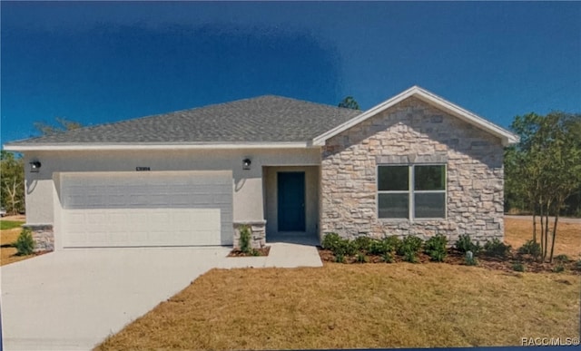 view of front facade featuring a front yard and a garage