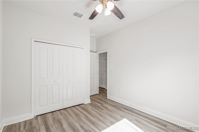 unfurnished bedroom with a closet, light hardwood / wood-style flooring, and ceiling fan