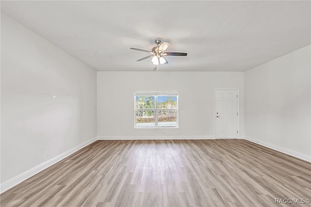 empty room featuring light hardwood / wood-style flooring and ceiling fan