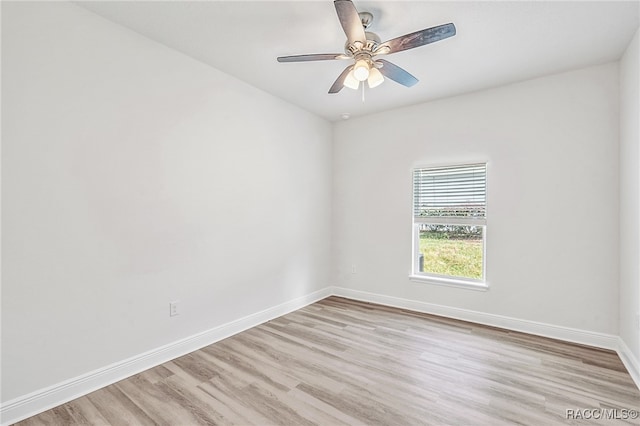 spare room featuring light hardwood / wood-style flooring and ceiling fan