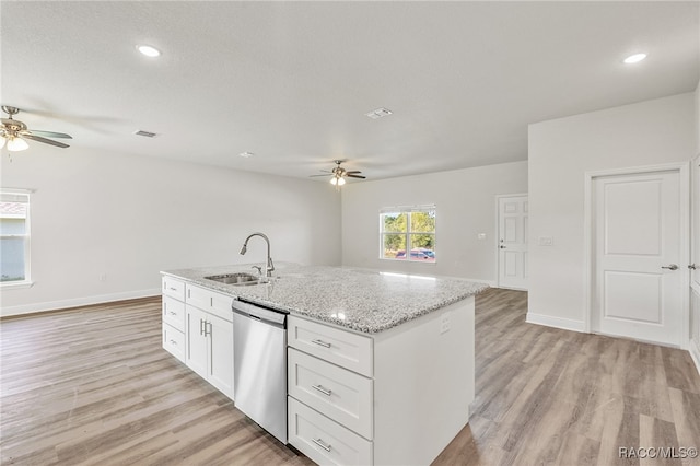 kitchen featuring white cabinetry, sink, stainless steel dishwasher, light hardwood / wood-style floors, and a kitchen island with sink