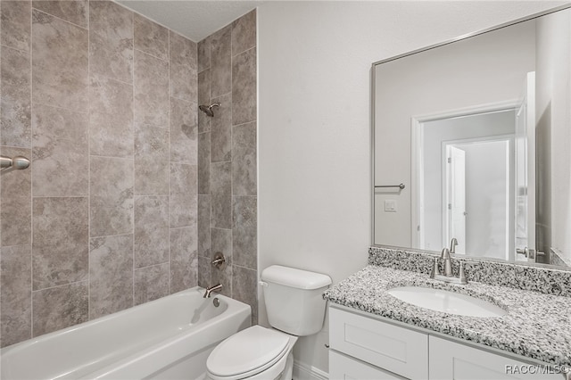 full bathroom with toilet, vanity, and tiled shower / bath