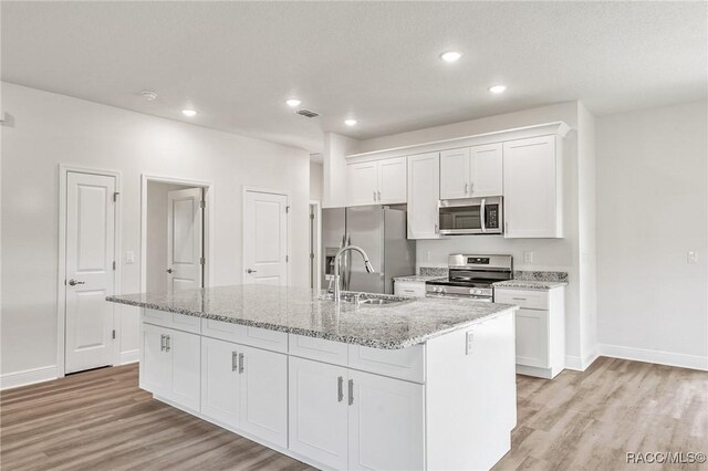44 W Lynnhaven Pl, Citrus Springs, FL 34434 - kitchen with appliances with stainless steel finishes, a sink, light wood-type flooring, white cabinets, and recessed lighting