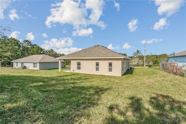 back of house featuring a yard