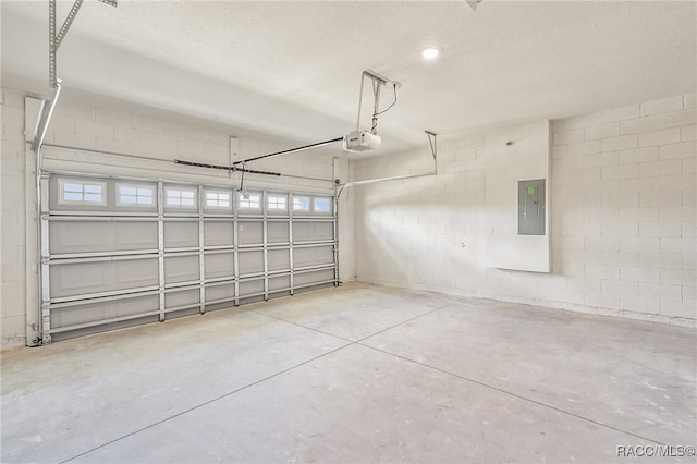 garage with electric panel and a garage door opener