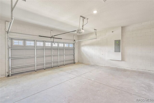44 W Lynnhaven Pl, Citrus Springs, FL 34434 - garage with a garage door opener, electric panel, and concrete block wall