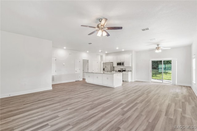 unfurnished living room featuring ceiling fan and light hardwood / wood-style floors