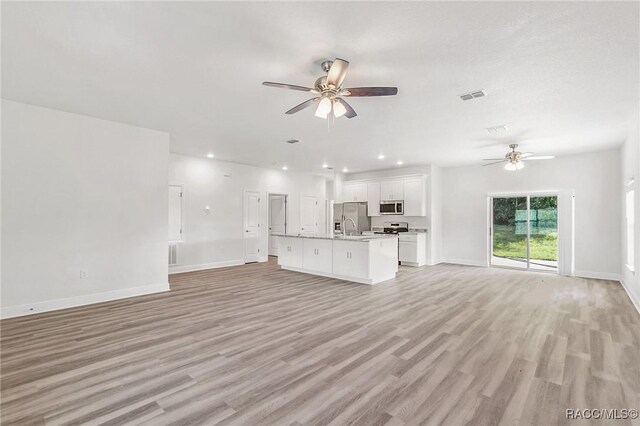 44 W Lynnhaven Pl, Citrus Springs, FL 34434 - unfurnished living room with a ceiling fan, light wood finished floors, baseboards, and recessed lighting