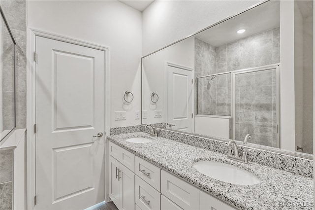 bathroom with vanity and a shower with shower door