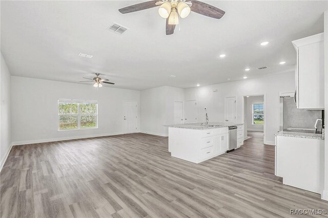 44 W Lynnhaven Pl, Citrus Springs, FL 34434 - kitchen with ceiling fan, white cabinets, baseboards, light wood-type flooring, and recessed lighting