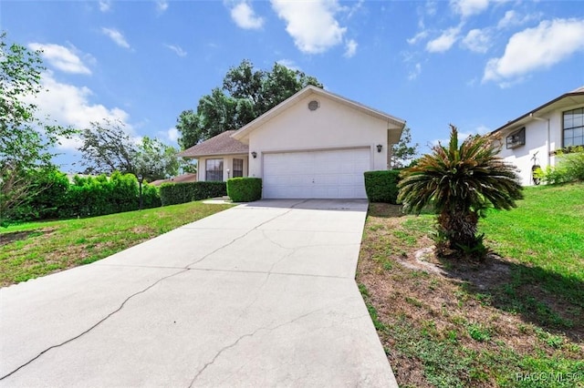 ranch-style house with an attached garage, stucco siding, driveway, and a front yard