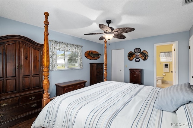 bedroom with hardwood / wood-style floors, ceiling fan, a textured ceiling, and ensuite bath