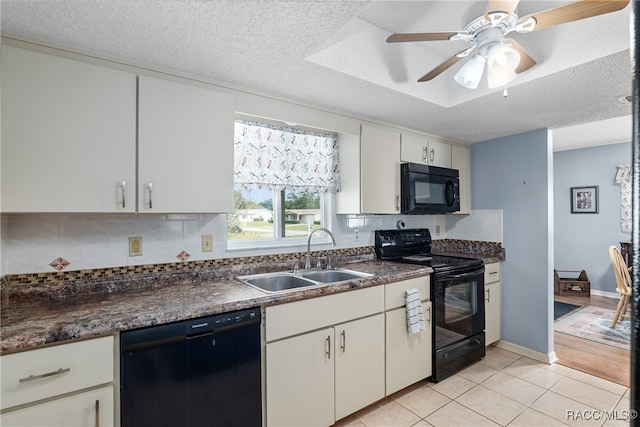 kitchen with decorative backsplash, a textured ceiling, sink, black appliances, and white cabinets