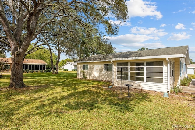 rear view of house with a yard