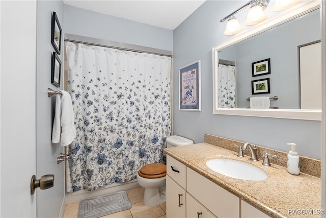 bathroom featuring vanity, tile patterned floors, toilet, a textured ceiling, and walk in shower