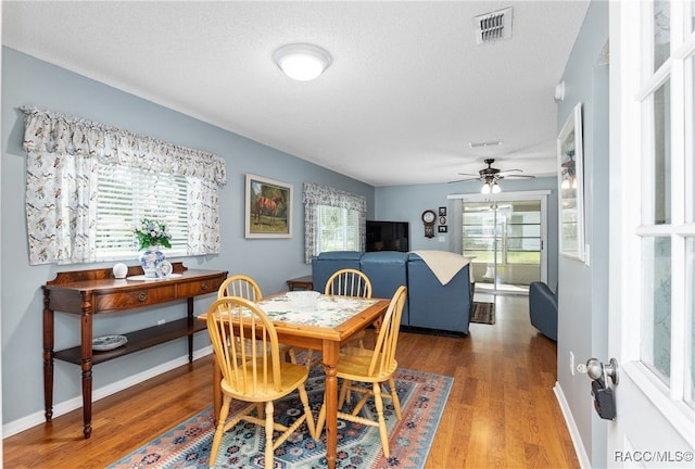 dining area featuring hardwood / wood-style flooring, ceiling fan, and a healthy amount of sunlight