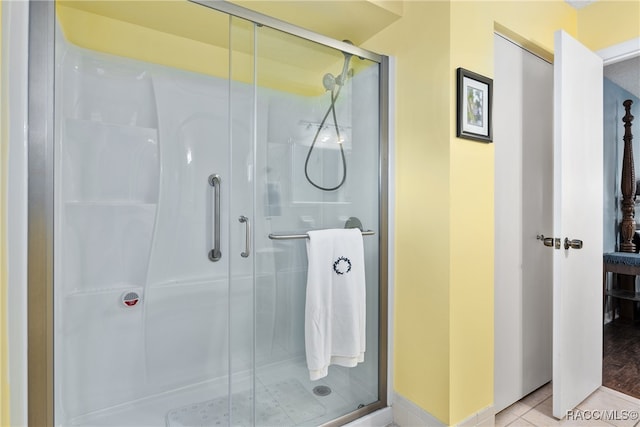 bathroom featuring tile patterned floors and a shower with door