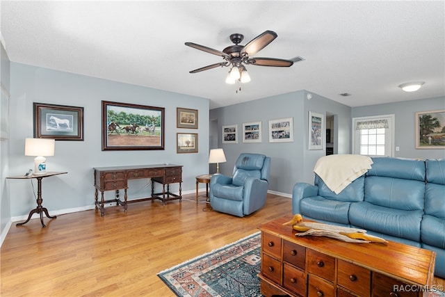 living room with light hardwood / wood-style flooring and ceiling fan