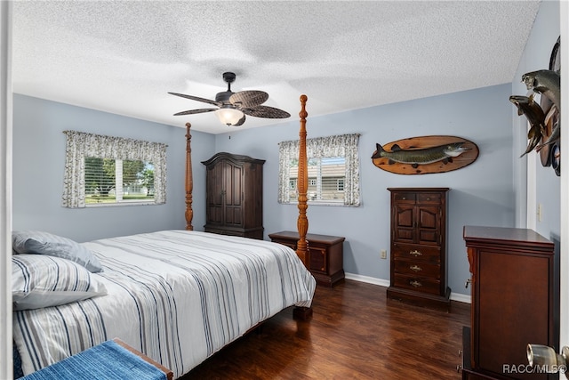 bedroom with a textured ceiling, ceiling fan, and dark wood-type flooring