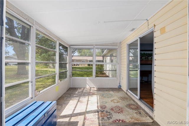 unfurnished sunroom featuring vaulted ceiling