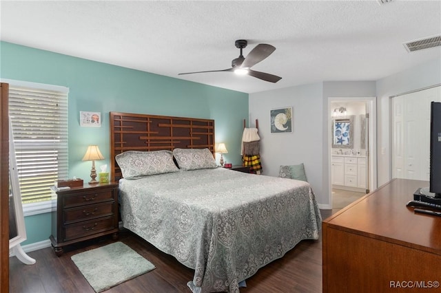 140 W Frisco Ln, Citrus Springs, FL 34434 - bedroom featuring dark wood finished floors, a ceiling fan, and connected bathroom
