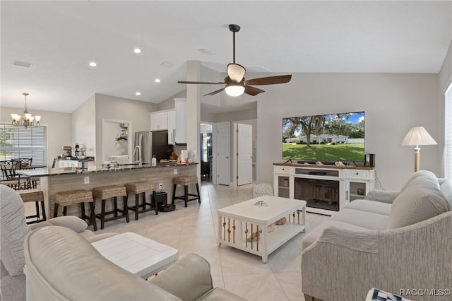 140 W Frisco Ln, Citrus Springs, FL 34434 - living room featuring light tile patterned floors, lofted ceiling, a chandelier, plenty of natural light, and a ceiling fan