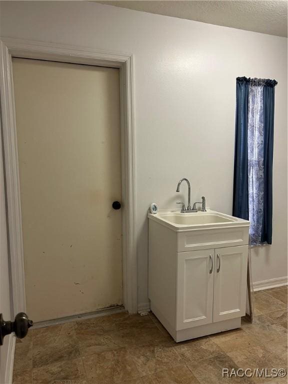 bathroom featuring vanity and a textured ceiling