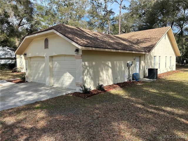 view of side of home with a garage and central AC unit