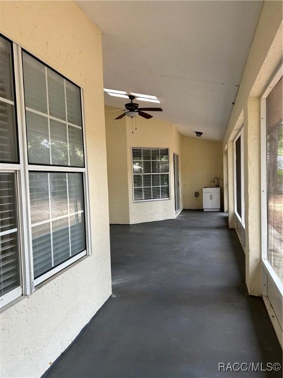 view of patio featuring ceiling fan