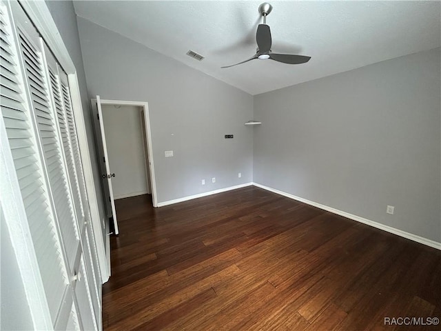 unfurnished bedroom with vaulted ceiling, dark hardwood / wood-style floors, and ceiling fan