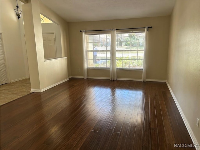 unfurnished room featuring dark hardwood / wood-style flooring