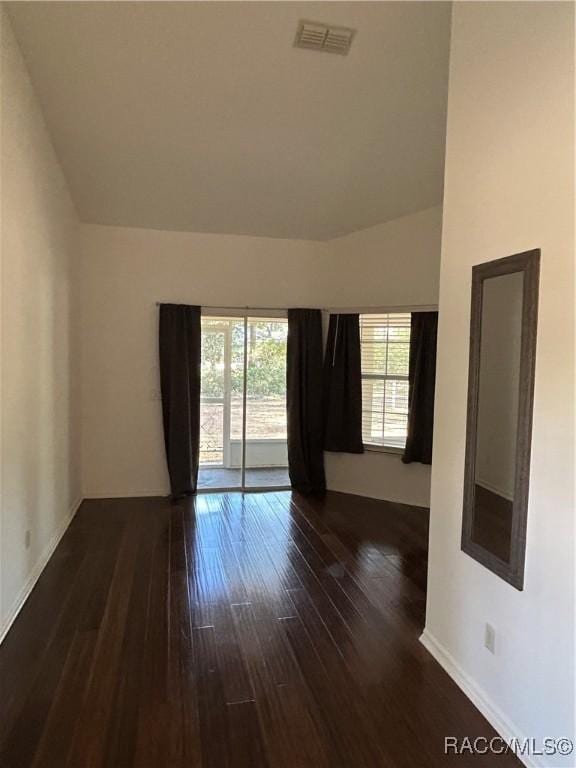 empty room with dark wood-type flooring