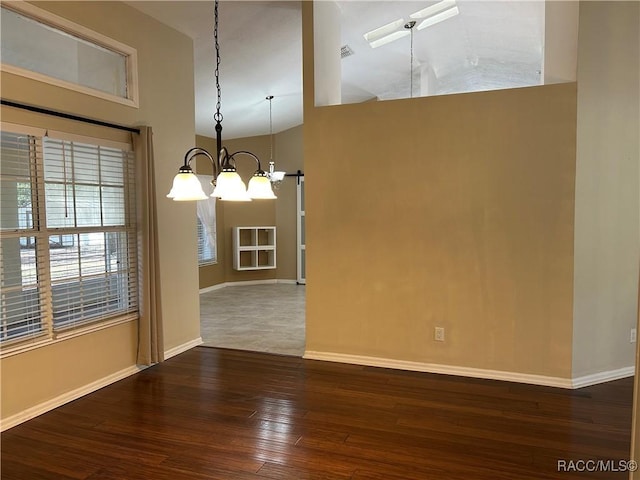 unfurnished dining area with a notable chandelier and dark hardwood / wood-style floors