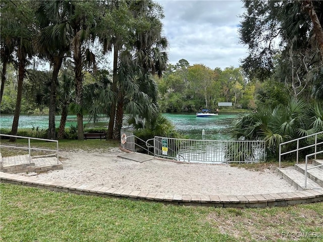 view of property's community featuring a water view and volleyball court