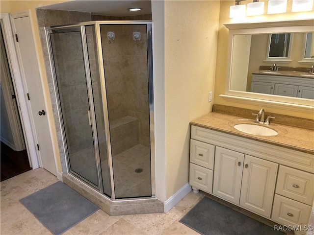 bathroom with walk in shower, tile patterned floors, and vanity