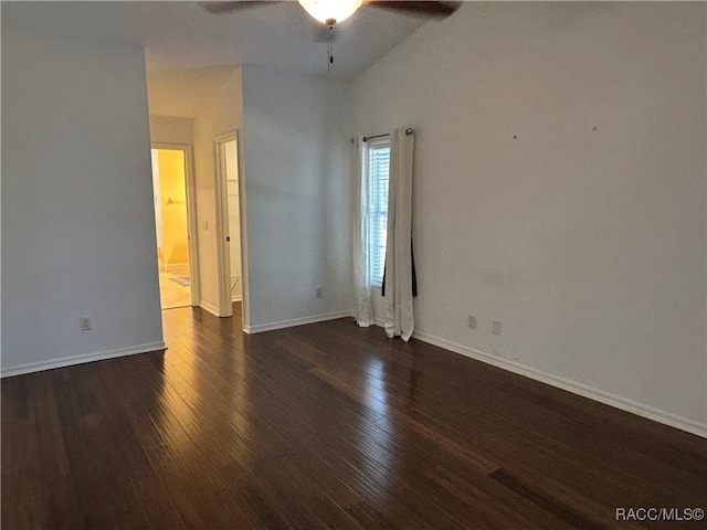 spare room featuring lofted ceiling, dark hardwood / wood-style floors, and ceiling fan