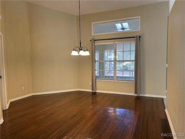 unfurnished dining area featuring dark hardwood / wood-style flooring and a chandelier