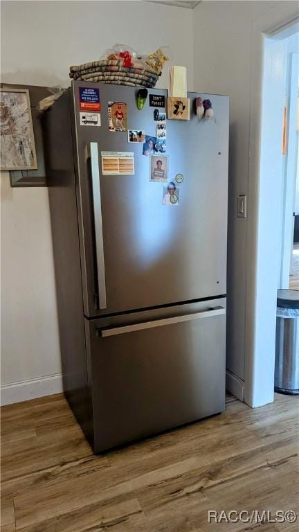 details featuring stainless steel refrigerator and hardwood / wood-style flooring