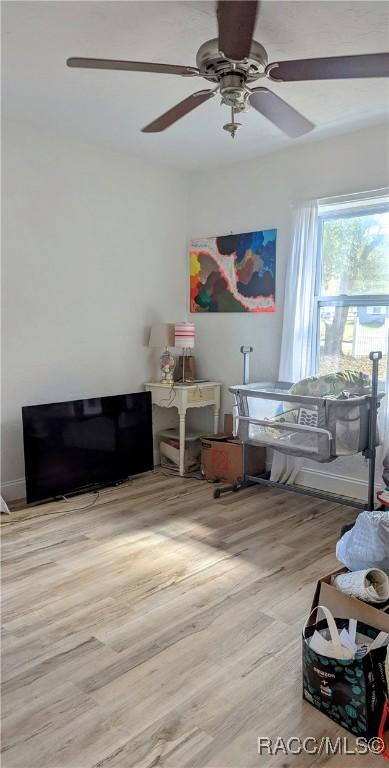 bedroom featuring ceiling fan and light hardwood / wood-style floors