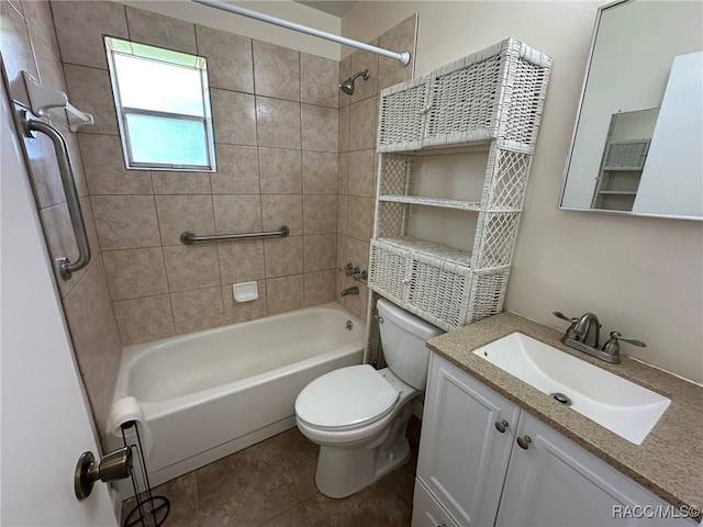 full bathroom with tiled shower / bath combo, vanity, tile patterned floors, and toilet