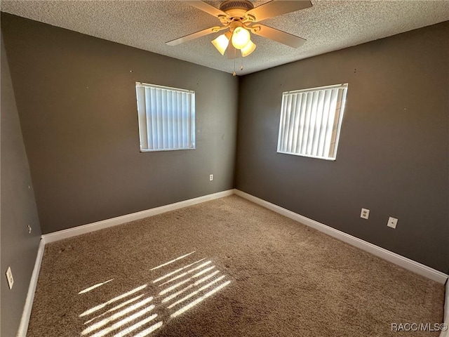 unfurnished room with ceiling fan, carpet floors, and a textured ceiling