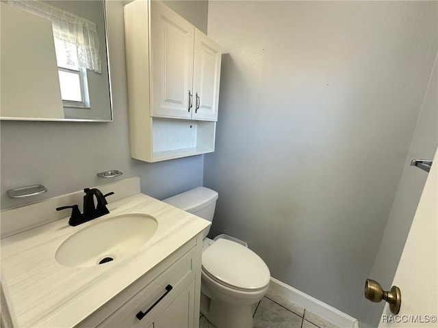 bathroom with tile patterned floors, vanity, and toilet