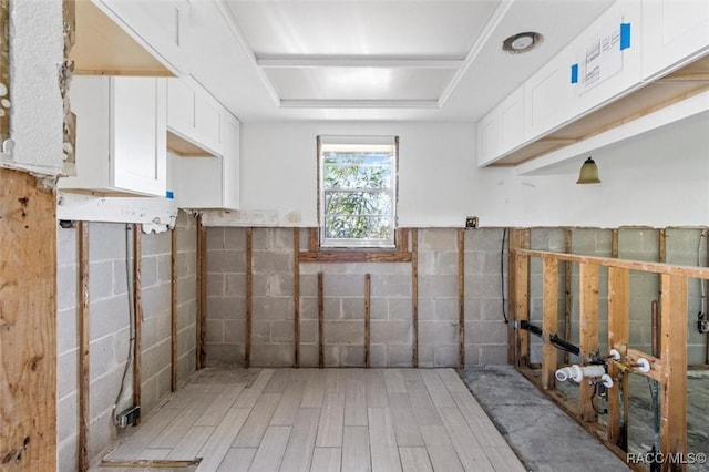 interior space featuring a tray ceiling and wood finished floors