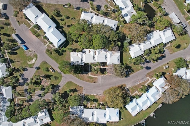 drone / aerial view with a residential view and a water view